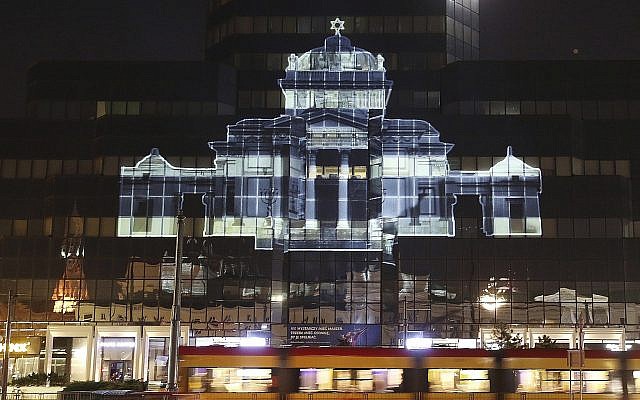 The Great Synagogue of Warsaw, which was destroyed by the German forces during World War II, was recreated virtually with light as part of anniversary commemorations of the 1943 uprising in the Warsaw Ghetto, in Warsaw, Poland, Thursday, April 18, 2019. The multimedia installation, which included the archival recordings of a prewar cantor killed in the Holocaust, is the work of Polish artist Gabi von Seltmann. It was organized by a group that fights anti-Semitism. (AP Photo/Czarek Sokolowski)