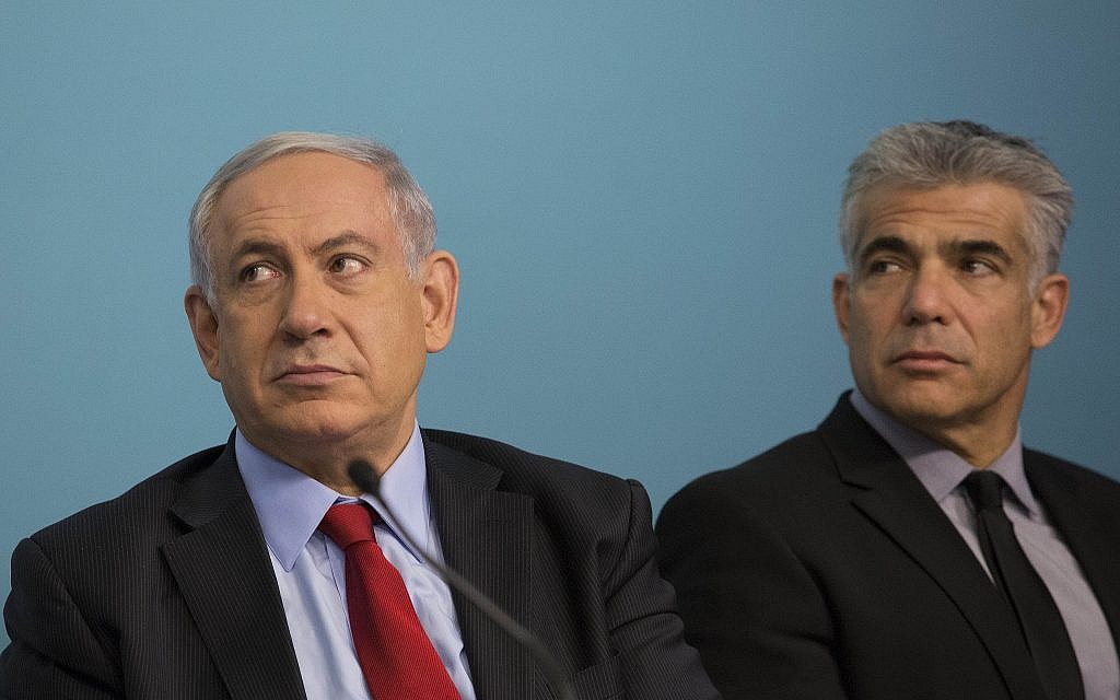 Prime Minister Benjamin Netanyahu (L) and then-finance minister Yair Lapid at a signing ceremony for a new private port to be built in the southern Israeli city of Ashdod, at the Prime Minister's Office in Jerusalem on September 23, 2014. (Noam Revkin Fenton/Flash90)