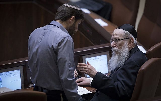 Then-Jewish Home MK Bezalel Smotrich, left, speaks with then-health minister Yaakov Litzman during a plenary session in the Knesset on January 25, 2017. (Yonatan Sindel/Flash90)