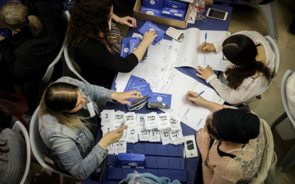Illustrative: Israelis count the remaining ballots from soldiers and absentees at the parliament in Jerusalem, a day after the general elections, April 10, 2019. (Noam Revkin Fenton/Flash90)