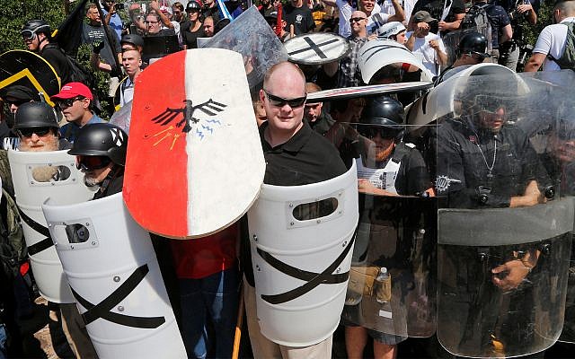 Illustrative: White nationalist demonstrators use shields to guard the entrance to Lee Park in Charlottesville, Virginia, August 12, 2017. (AP Photo/Steve Helber, File)