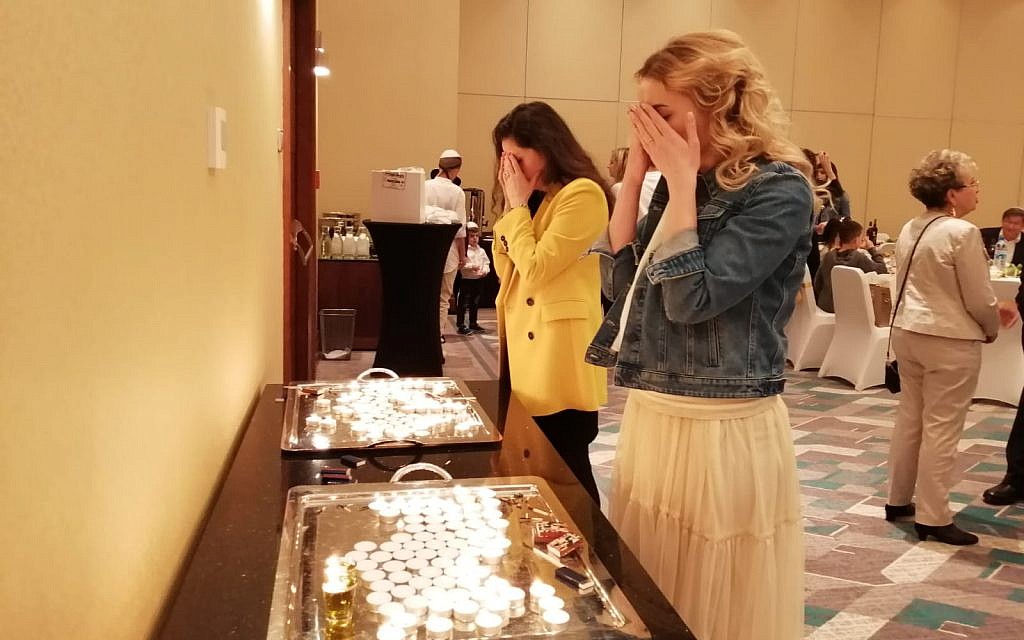 Attendees gather to light the holiday candles ahead of sunset at the Warsaw Hilton, April 19, 2019. (Courtesy Chabad of Warsaw)