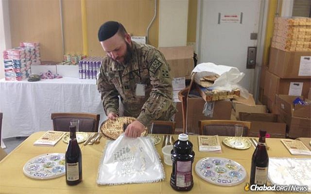 US Army Capt. Mendy Stern, chaplain for the 312th Military Intelligence Battalion, sets up for a Passover seder for Jewish troops serving in Afghanistan. (Courtesy, Chabad)