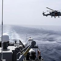 A picture taken from Cyprus' warship 'Ioannides' shows a Royal Navy Lynx helicopter taking part in the "Multinational CIMIC Exercise, ARGONAUT 2019, Search and Rescue (SAR) Operations, a rescue drill in which the militaries of Cyprus, Greece, France, Britain, Israel, Germany and the US participated on May 30, 2019. (Iakovos Hatzistavrou/AFP)