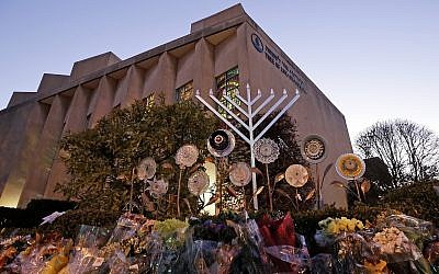 File: A menorah and flowers are seen outside the Tree of Life Synagogue in preparation for a celebration service on the first night of Hanukkah, in the Squirrel Hill neighborhood of Pittsburgh, December 2, 2018. (AP Photo/Gene J. Puskar)