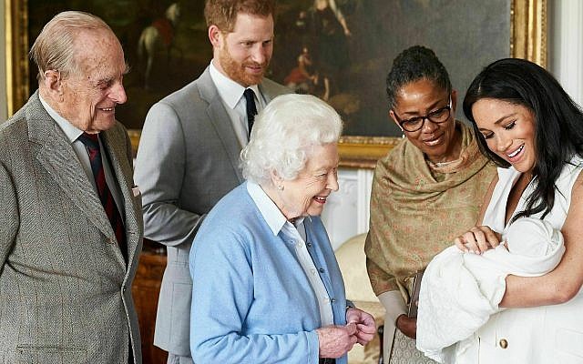 In this image made available by SussexRoyal on Wednesday May 8, 2019, Britain's Prince Harry and Meghan, Duchess of Sussex, joined by her mother Doria Ragland, show their new son to Queen Elizabeth II and Prince Philip at Windsor Castle, Windsor, England.  (Chris Allerton/SussexRoyal via AP)