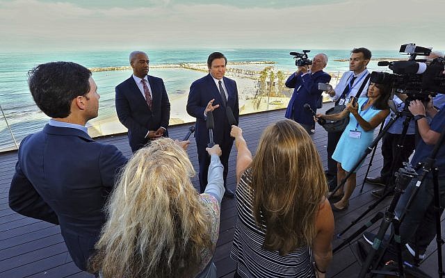 With the Mediterranean Sea as a backdrop, Florida Gov. Ron DeSantis speaks to reporters on May 27, 2019, ahead of the first full day of a Florida trade delegation trip to Israel. (Jeff Schweers/Tallahassee Democrat via AP)
