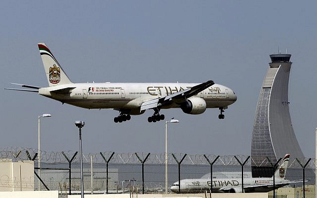 In this May 4, 2014, photo, an Etihad Airways plane prepares to land at the Abu Dhabi airport in the United Arab Emirates (AP Photo/Kamran Jebreili)