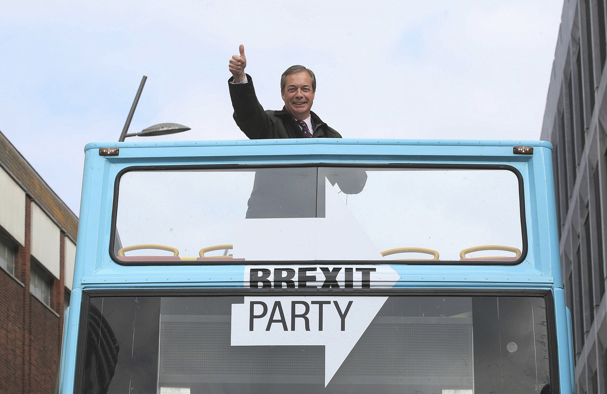 Brexit Party leader Nigel Farage gestures on an open topped bus while on the European Election campaign trail in Sunderland, England, Saturday, May 11, 2019. (Danny Lawson/PA via AP)