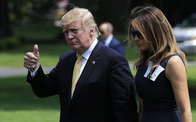 President Donald Trump with first lady Melania Trump gestures upon arrival at the White House in Washington, Tuesday, May 28, 2019, from a state visit in Japan. (AP Photo/Manuel Balce Ceneta)