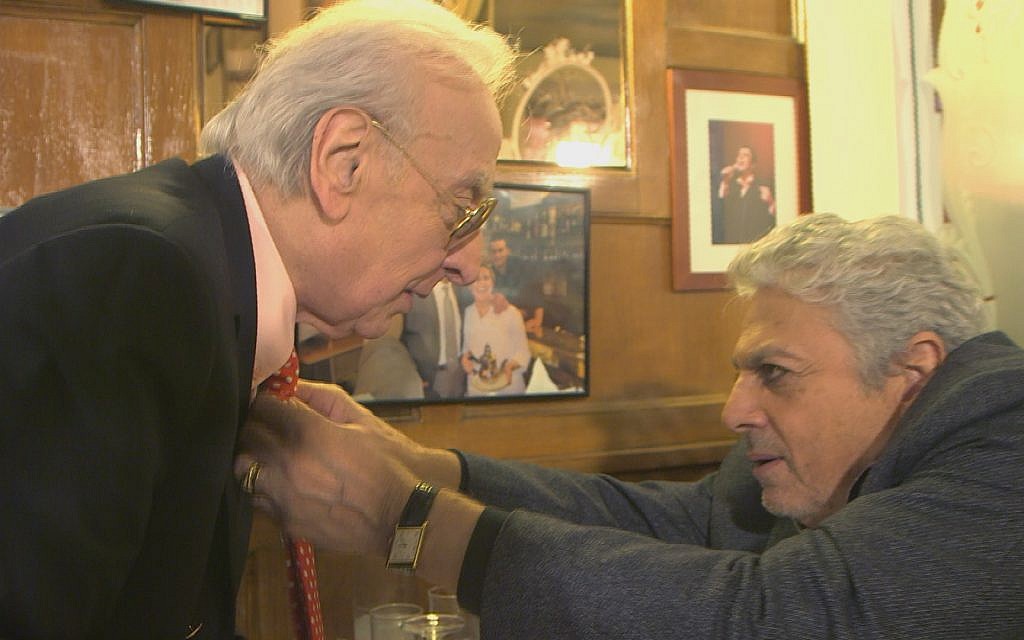 Singer Enrico Macias, right, straightens the necktie of fellow 'Magnifique' comedian Robert Castel. (Courtesy Yves Azeroual)