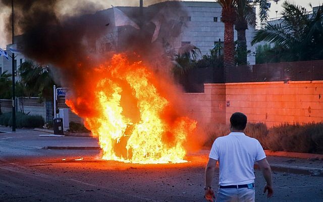 A car bursts into flames after it was hit by a rocket fired from the Gaza Strip in the southern Israeli city of Ashdod on May 5, 2019. (Flash90)
