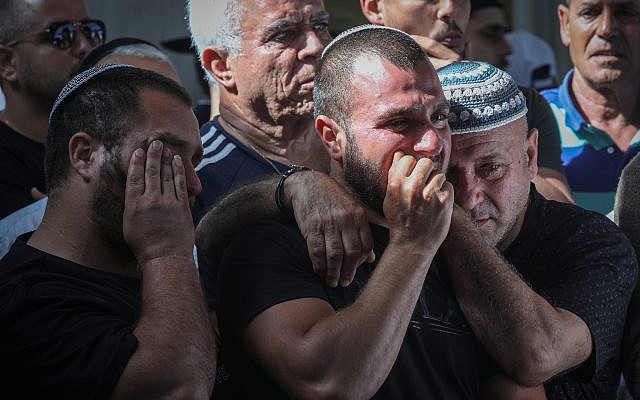 Friends and relatives mourn as they attend the funeral of 58-year-old Moshe Agadi, who was killed from shrapnel wounds after his house was hit directly by a rocket fired from the Gaza Strip in Ashkelon, southern Israel, on May 5, 2019. (Noam Rivkin Fenton/Flash90)