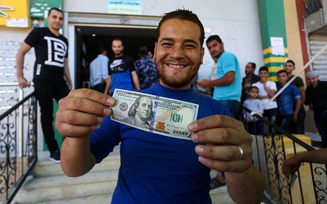 Palestinians receive financial aid as part of $480 million allocated for assistance by Qatar, at a post office in Gaza City on May 19, 2019. (Abed Rahim Khatib/Flash90)