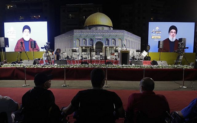 Lebanese Shiite Muslims listen to a speech by the head of the terror group Hezbollah, Hassan Nasrallah, transmitted on two large screens with a replica of the Dome of the Rock mosque, during the al-Quds (Jerusalem) International Day, in a southern suburb of the capital Beirut on May 31, 2019 (Anwar AMRO / AFP)