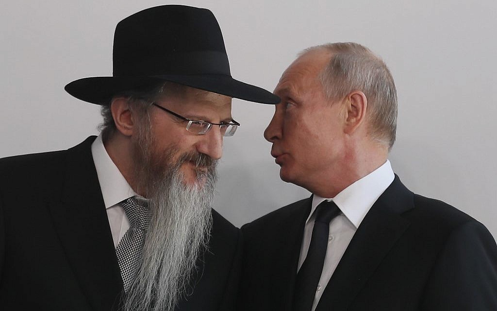 Illustrative: Russian President Vladimir Putin (right) speaks with Chief Rabbi of Russia Berel Lazar (left), during a ceremony unveiling the memorial to members of the Jewish resistance in Nazi concentration camps during World War II, at the Jewish Museum and Tolerance Center in Moscow, on June 4, 2019. (Sergei Ilnitsky/Pool/AFP)