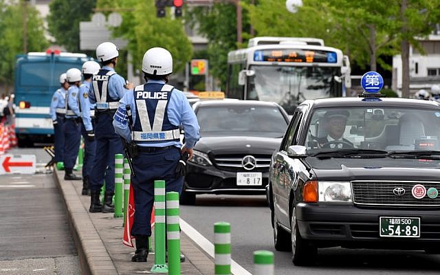 Police officers check traffic near the G20 Finance Ministers and Central Bank Governors meeting site in Fukuoka on June 7, 2019. (Toshifumi KITAMURA / AFP)