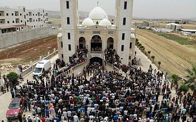 A picture taken with a drone on June 9, 2019 shows Syrians attending the funeral of late rebel fighter Abdel-Basset al-Sarout, in al-Dana in Syria's jihadist-controlled Idlib region, near the border with Turkey. (Omar Haj Kadour/AFP)