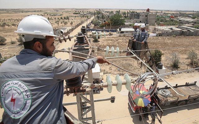 Palestinian electrical workers inspect power installations in the southern Gaza city of Rafah on June 25, 2019. (Said Khatib/AFP)