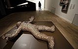 Illustrative: A woman walks past the artwork 'Golem' by Joshua Abrabanel during a press presentation for the 'Golem' exhibition at the Jewish Museum in Berlin, Germany, September 22, 2016. (AP Photo/Michael Sohn)