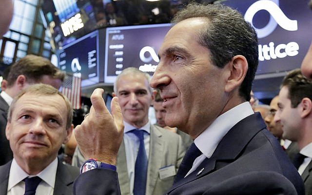 Altice founder Patrick Drahi, right, waits with company executives for the Altice IPO to begin trading, on the floor of the New York Stock Exchange, Thursday, June 22, 2017. (AP Photo/Richard Drew)