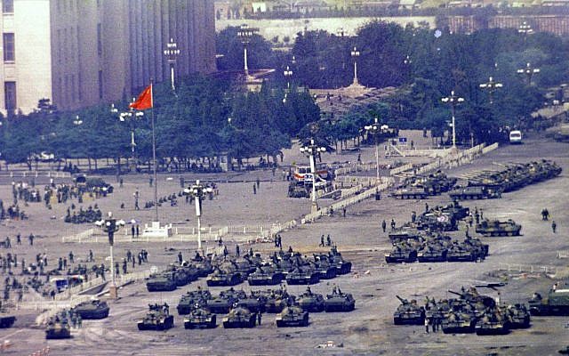 FILE - In this June 5, 1989 photo, Chinese troops and tanks gather in Beijing, one day after the military crackdown that ended a seven week pro-democracy demonstration on Tiananmen Square.  (AP Photo/Jeff Widener, File)