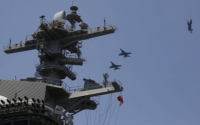 Three EA-18G Growlers from the "Patriots" of Electronic Attack Squadron (VAQ) 140 participate in a change-of-command ceremony aboard the Nimitz-class aircraft carrier USS Abraham Lincoln (CVN 72) in the Arabian Sea on May 30, 2019. (Mass Communication Specialist 3rd Class Amber Smalley/US Navy via AP)