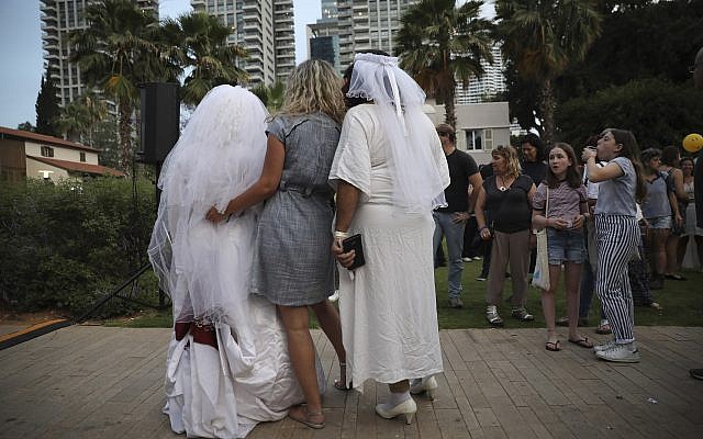 Gay couples take part in a mass same-sex wedding in Tel Aviv, Israel, Tuesday, June 4, 2019  (AP Photo/Oded Balilty)