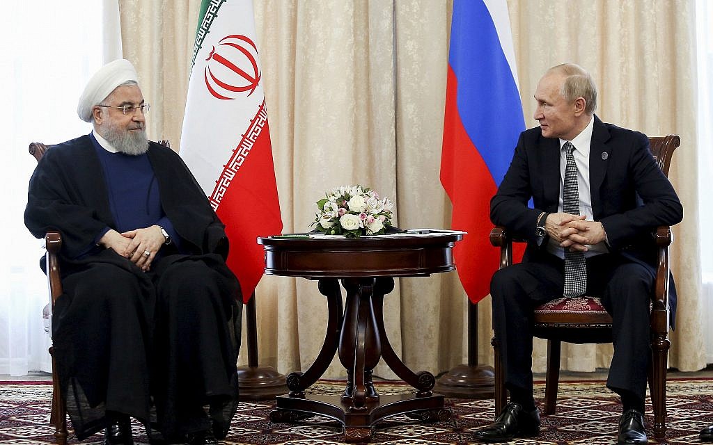 In this photo released on June 14, 2019, Russian President Vladimir Putin, right, and Iranian President Hassan Rouhani attend a meeting on the sideline of the Shanghai Cooperation Organization (SCO) summit, in Bishkek, Kyrgyzstan. (Iranian Presidency Office via AP)