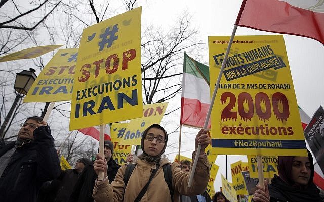 Supporters of Maryam Rajavi, President of the National Council of Resistance of Iran, demonstrate against Iranian President Hassan Rouhani's visit in Paris, January 27, 2016. (AP Photo/Christophe Ena)