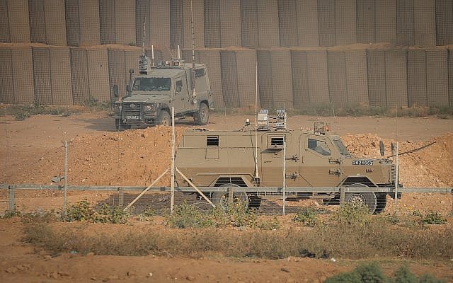 Illustrative: Israeli military vehicles are seen during clashes along the border fence between Israel and the Gaza Strip, near Gaza City, on June 28, 2019. (Hassan Jedi/Flash90)