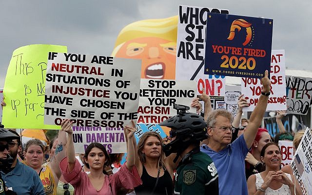 A large group of protestors holds a rally near where Trump announces his re-election campaign in Orlando, Florida, June 18, 2019. (AP Photo/Chris O’Meara)