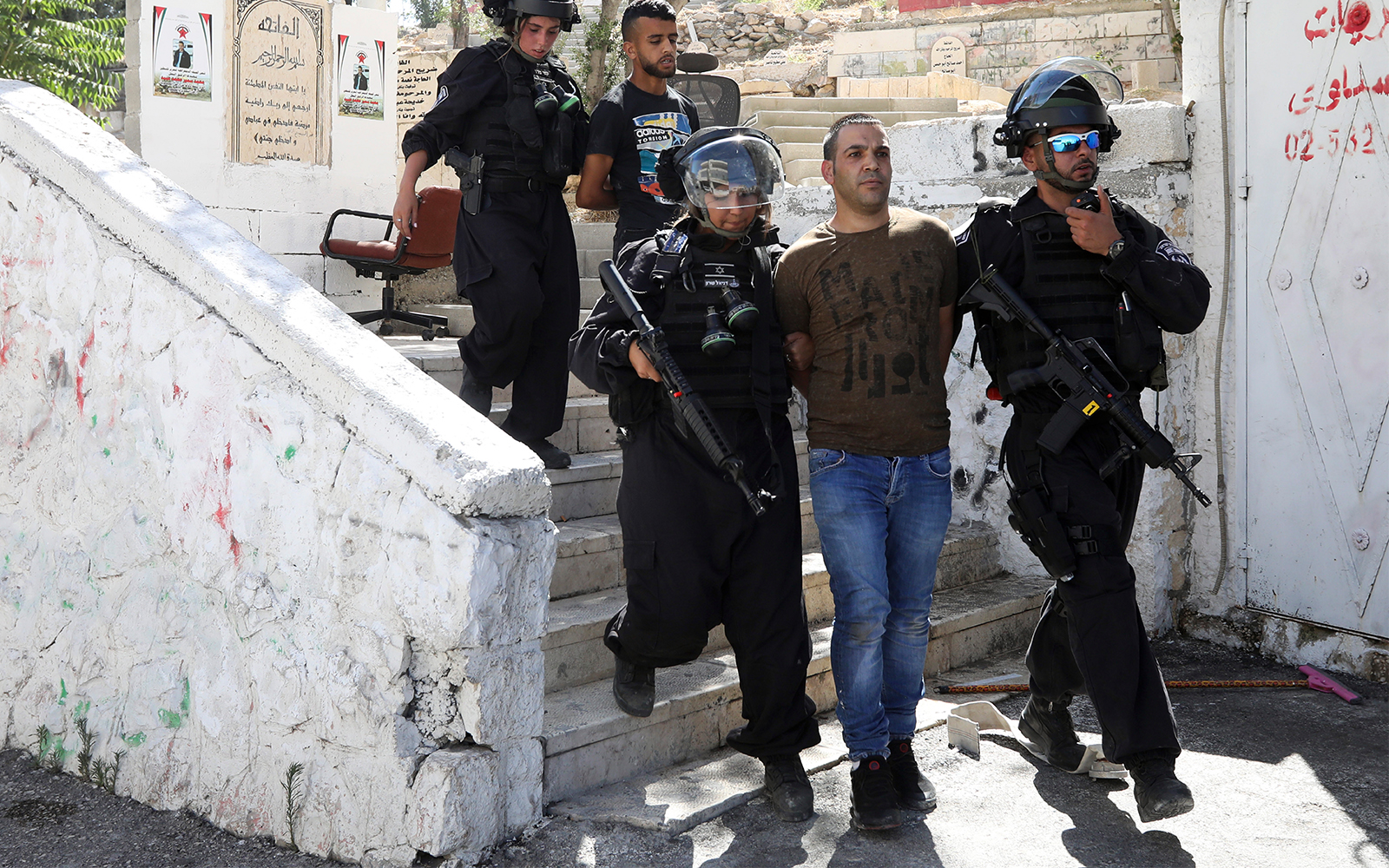 Palestinians are arrested during clashes with Israeli police in Jerusalem's neighborhood of Issawiya, June 28, 2019, a day after a Palestinian was shot and killed by police during a protest in the same neighborhood. (AP Photo/Mahmoud Illean)