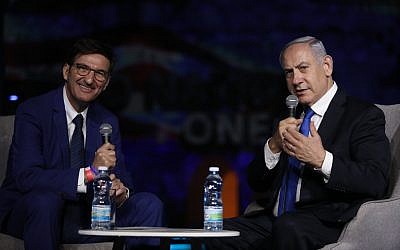 Then Prime Minister Benjamin Netanyahu (R) and Israel Hayom editor Boaz Bismuth speak at the Israel Hayom forum in Jerusalem on June 27, 2019. (Gideon Markovitz)