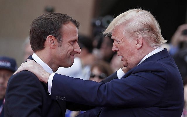 French President Emmanuel Macron, left, meets US President Donald Trump during a ceremony to mark the 75th anniversary of D-Day at the Normandy American Cemetery in Colleville-sur-Mer, Normandy, France, June 6, 2019. (Ian Langsdon/POOL via AP)