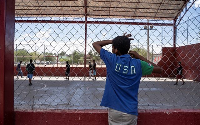 One of the residents of Iglesia Metodista "El Buen Pastor" migrant shelter watches the soccer match at a park near the shelter on June 09, 2019. (Paul Ratje / AFP)