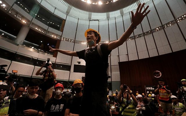 A protester gestures after they broke into the parliament chamber of the government headquarters in Hong Kong on July 1, 2019, on the 22nd anniversary of the city's handover from Britain to China.  (VIVEK PRAKASH / AFP)