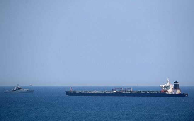 A British Royal Navy ship (L) patrols near supertanker Grace 1, which is suspected of carrying Iranian crude oil to Syria in violation of EU sanctions, after it was detained off the coast of Gibraltar on July 4, 2019. (Jorge Guerrero/AFP)