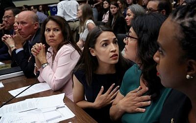 Rep. Alexandria Ocasio-Cortez (D-NY) (C) confers with U.S. Rep. Rashida Tlaib, (D-MI) (2nd R) and Rep. Ayanna S. Pressley (D-MA) (R) during a House Oversight and Reform Committee hearing July 12, 2019 in Washington, DC. (Win McNamee/Getty Images/AFP)