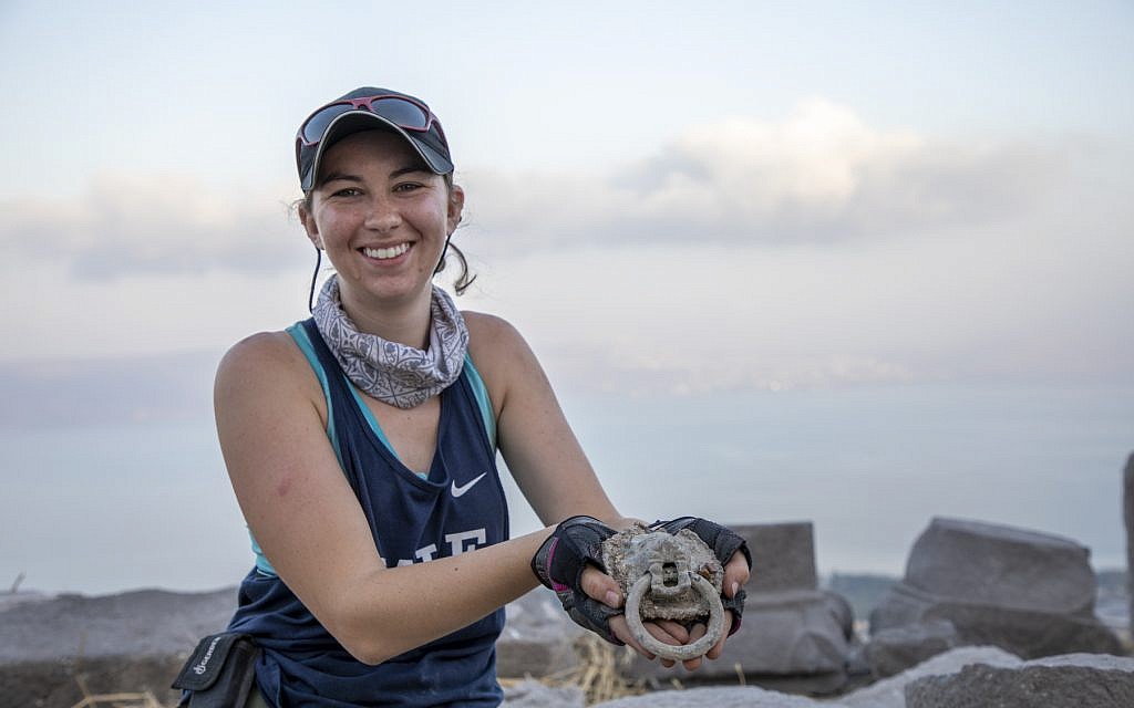 Area supervisor Jessica Rentz holds the Lion Head Knocker discovered at the 'Burnt Church' at the Hippos-Sussita Excavation Project at the Susita National Park, summer 2019. (courtesy)