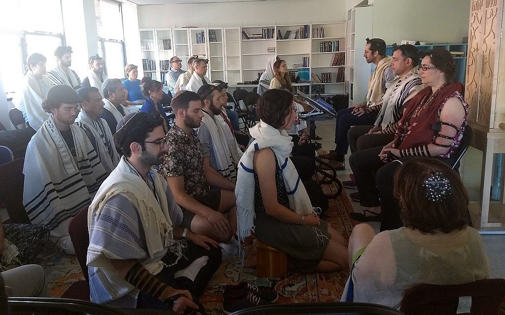 Illustrative: Students meditate as part of the morning prayer at Romemu Yeshiva in New York, July 16, 2019. The yeshiva combines intensive study of Jewish text with mindfulness and mysticism. (Ben Sales)