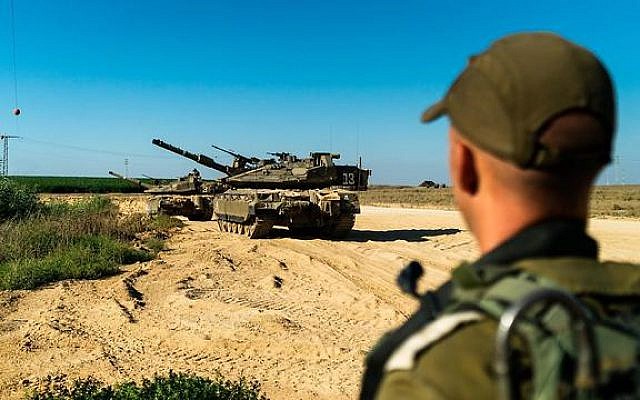 An IDF soldier and a tank during a military drill near the Gaza Strip, late July 2019. (IDF)