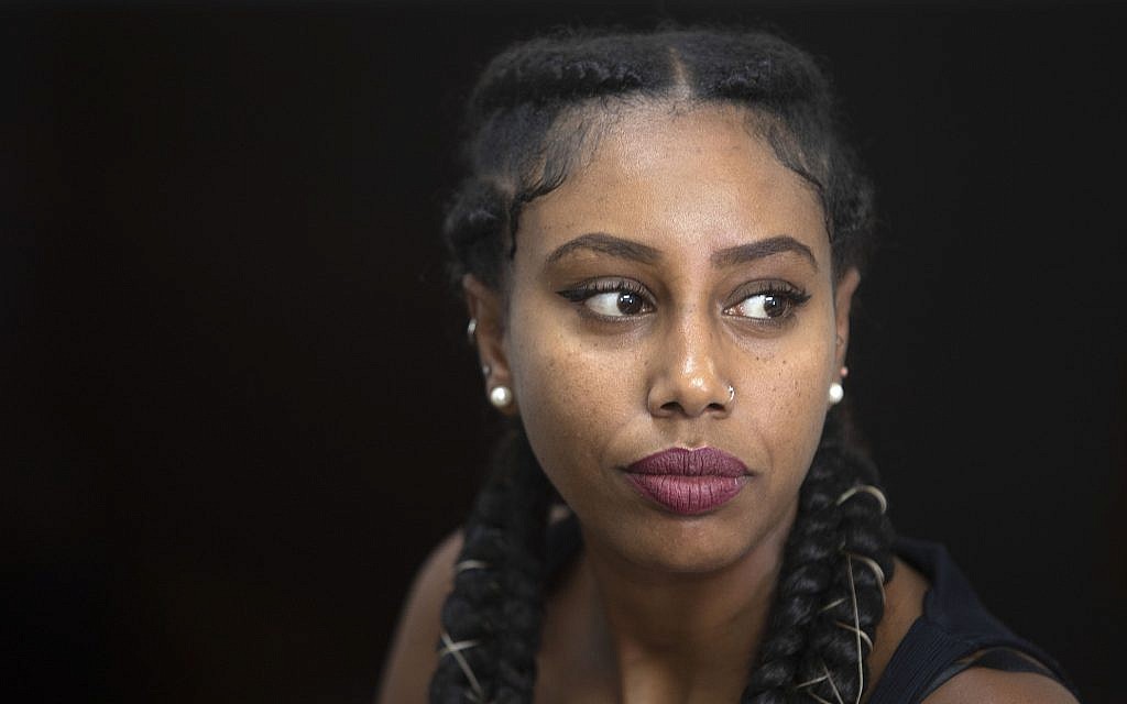 In this Sunday, July 7, 2019 photo, Ethiopian-Israeli musician Yael Mentesnot gives an interview to The Associated Press, in her house in Tel Aviv (AP Photo/Sebastian Scheiner)