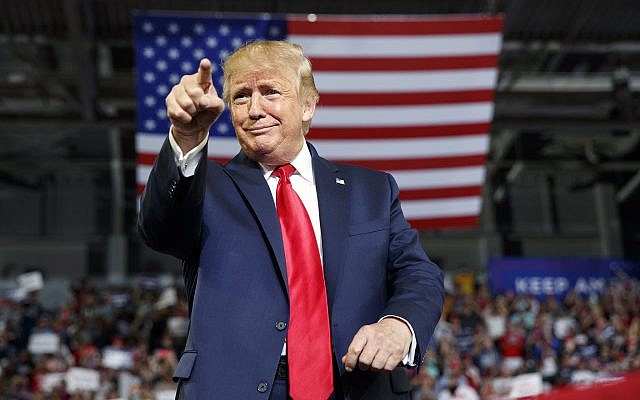 US President Donald Trump gestures to the crowd as he arrives to speak at a campaign rally at Williams Arena in Greenville, North Carolina, July 17, 2019. (Carolyn Kaster/AP)