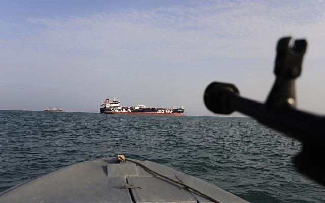 A speedboat of Iran's Revolutionary Guard trains a weapon toward the British-flagged oil tanker Stena Impero, which was seized in the Strait of Hormuz by the Guard, in the Iranian port of Bandar Abbas, July 21, 2019. (Morteza Akhoondi/Tasnim News Agency via AP)