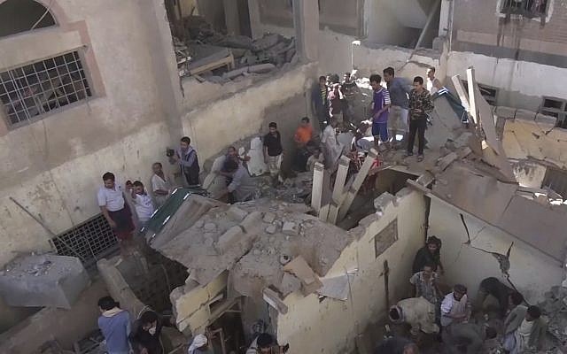 In this frame grab from from video, people search in the rubble following Saudi-led coalition airstrikes that killed at least six, including children, officials said, in the residential center of the capital, Sanaa, Yemen, May 16, 2019. (AP Photo)