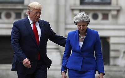 Britain's Prime Minister Theresa May and US President Donald Trump walk through the Quadrangle of the Foreign Office for a joint press conference in central London, June 4, 2019. (AP Photo/Frank Augstein)
