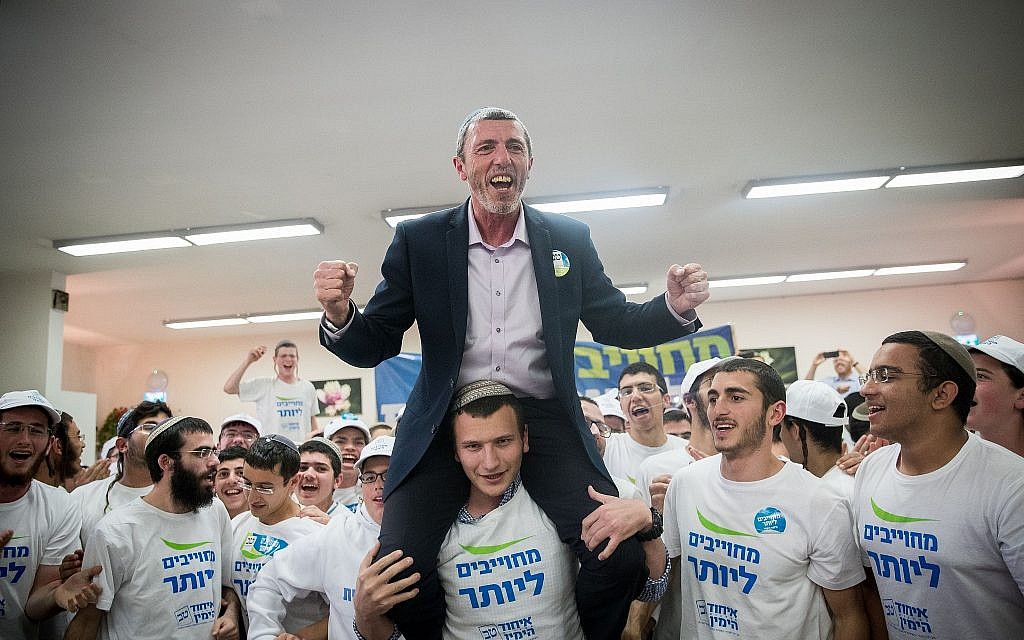 Rafi Peretz, leader of the Jewish Home party, dances with activists of the Union of Right-Wing Parties in Jerusalem, April 8, 2019 (Yonatan Sindel/Flash90)
