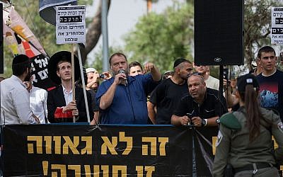 Illustrative: Otzma Yehudit member Benzi Gopstein (with microphone), head of the radical group Lehava, leads a demonstration against the Jerusalem Gay Pride parade on June 6, 2019. (Yonatan Sindel/Flash90)