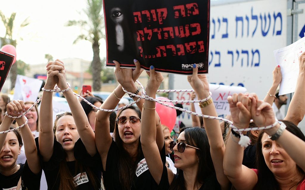 Parents protest against the abuse of children in private daycare centers in Tel Aviv on July 7, 2019. The sign reads 'What happens when the door is closed?' (Tomer Neuberg/Flash90)